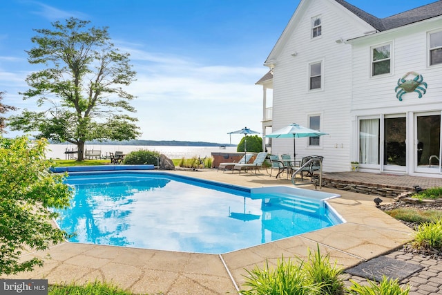 view of swimming pool featuring a patio, a water view, and a fenced in pool