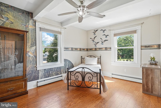 bedroom featuring a baseboard radiator, beam ceiling, a ceiling fan, and wood finished floors