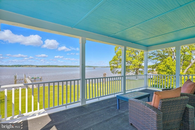 sunroom with a water view and a healthy amount of sunlight