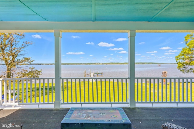 unfurnished sunroom featuring a water view