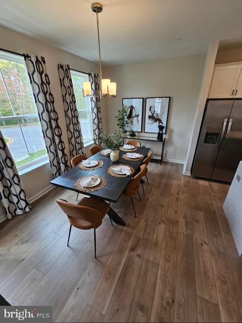 7304 Roxy Run, Clinton, MD 20735 - dining room featuring baseboards, an inviting chandelier, and hardwood / wood-style floors