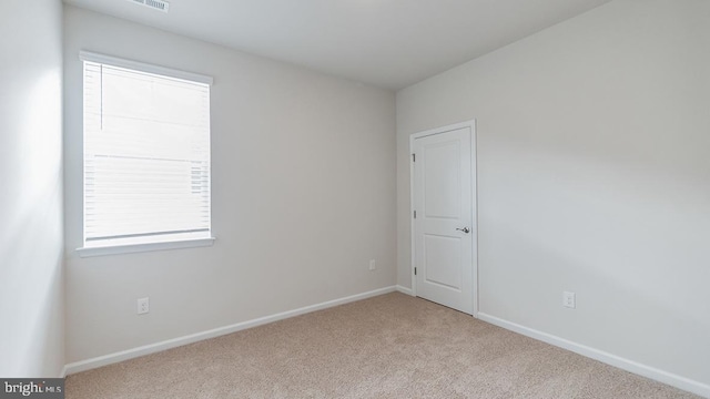 unfurnished room featuring baseboards and carpet