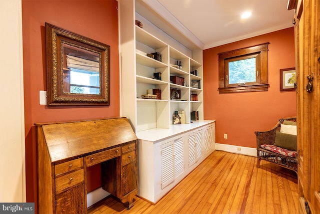 unfurnished room featuring baseboards, a wealth of natural light, ornamental molding, and light wood-type flooring