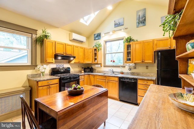 kitchen with a wall unit AC, a sink, a skylight, black appliances, and under cabinet range hood