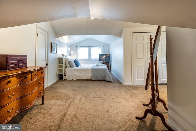 bedroom featuring lofted ceiling, carpet floors, and baseboards