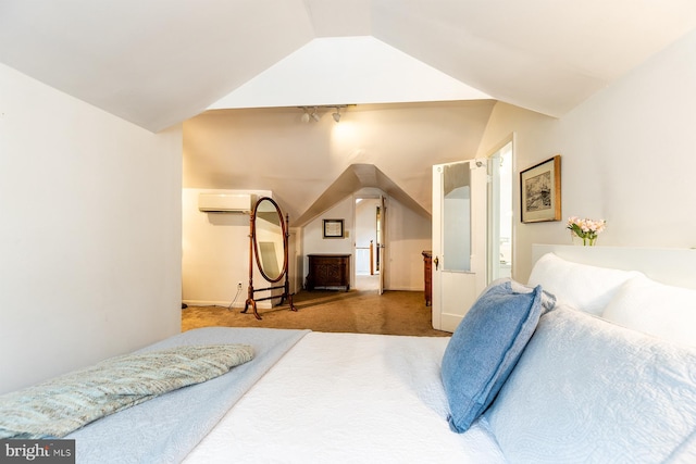 carpeted bedroom with baseboards, vaulted ceiling, and an AC wall unit