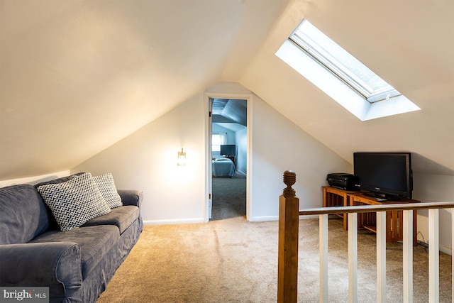 interior space with baseboards and lofted ceiling with skylight
