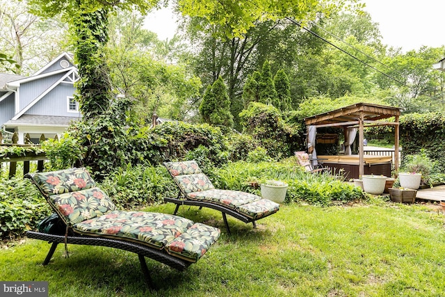 view of yard with a hot tub and a gazebo
