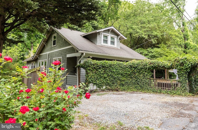 view of side of home featuring a shingled roof