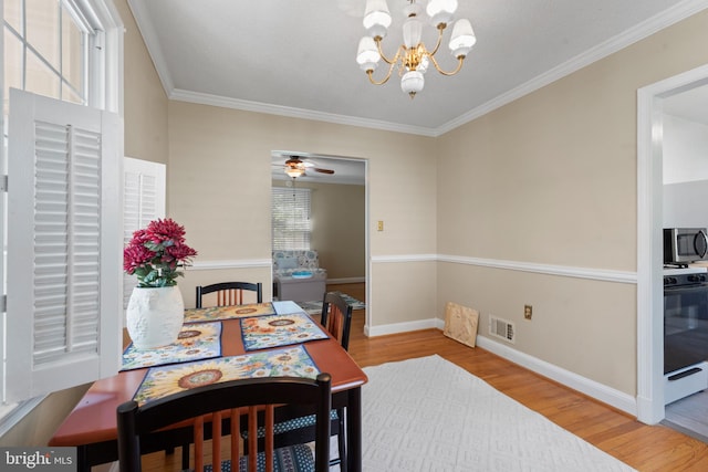 412 Linda Ave, Linthicum Heights, MD 21090 - dining space featuring wood finished floors, a chandelier, baseboards, and crown molding