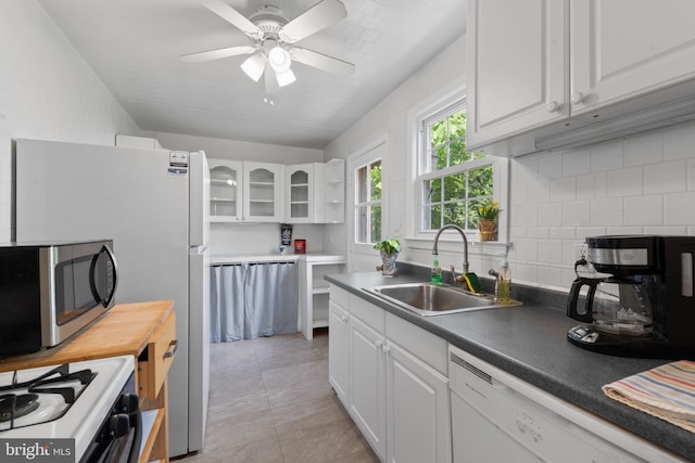 412 Linda Ave, Linthicum Heights, MD 21090 - kitchen featuring white appliances, a sink, white cabinetry, and backsplash