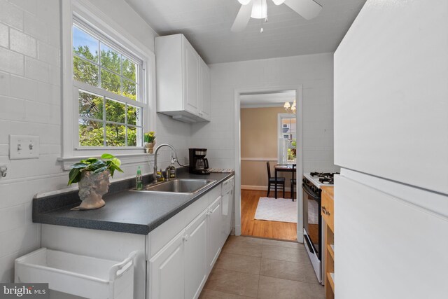 412 Linda Ave, Linthicum Heights, MD 21090 - kitchen with white appliances, a sink, white cabinets, and dark countertops