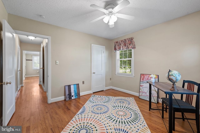 412 Linda Ave, Linthicum Heights, MD 21090 - office area with light wood-type flooring, healthy amount of natural light, baseboards, a ceiling fan, and a textured ceiling