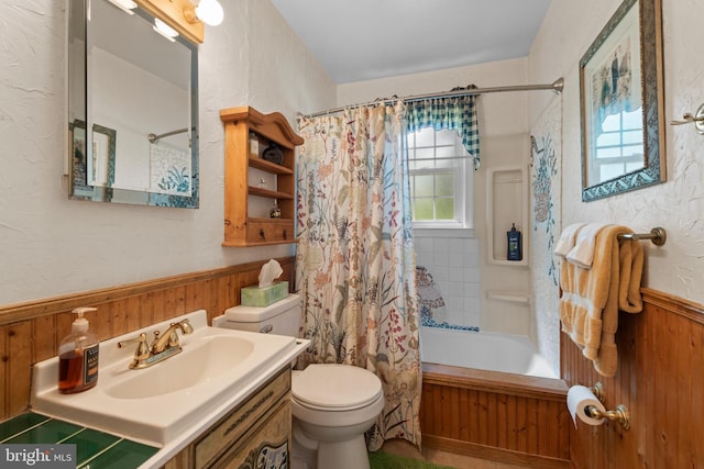 412 Linda Ave, Linthicum Heights, MD 21090 - full bath featuring wainscoting, toilet, wooden walls, shower / bath combo with shower curtain, and a textured wall