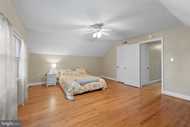 412 Linda Ave, Linthicum Heights, MD 21090 - bedroom with vaulted ceiling, light wood-style floors, baseboards, a ceiling fan, and a textured ceiling