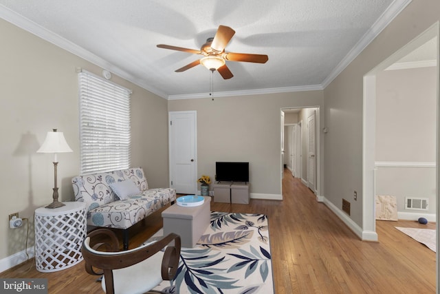 412 Linda Ave, Linthicum Heights, MD 21090 - living room with a ceiling fan, wood finished floors, baseboards, and ornamental molding