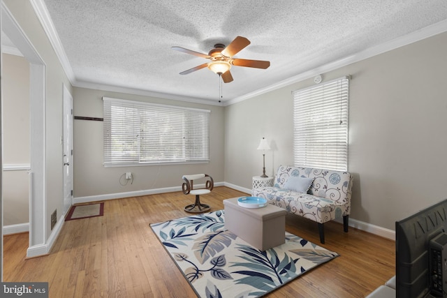 412 Linda Ave, Linthicum Heights, MD 21090 - living room featuring a ceiling fan, ornamental molding, a textured ceiling, hardwood / wood-style floors, and baseboards