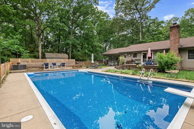 8543 Ingleton Rd, Easton, MD 21601 - view of pool with a fenced backyard, view of wooded area, a diving board, and a patio area