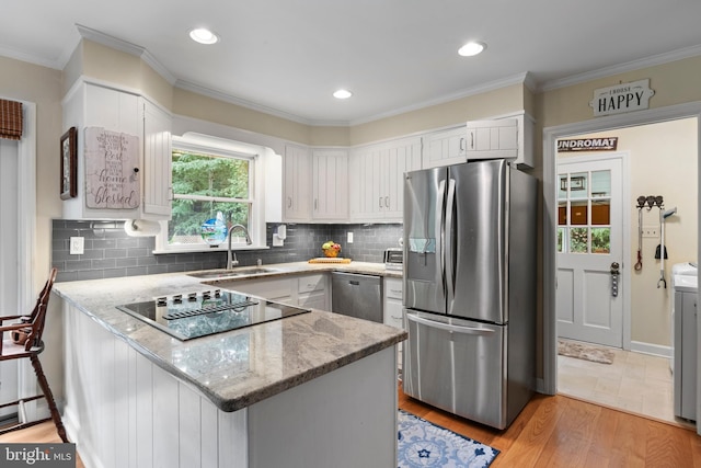 8543 Ingleton Rd, Easton, MD 21601 - kitchen with appliances with stainless steel finishes, a sink, a peninsula, light stone counters, and white cabinets