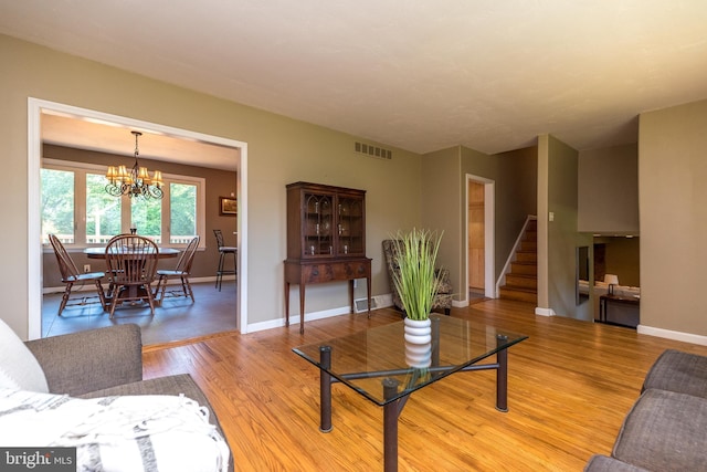 4537 Kavan Ct, Doylestown, PA 18902 - living room with stairway, a chandelier, light wood-style flooring, and baseboards