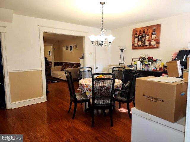 dining area with an inviting chandelier and wood finished floors