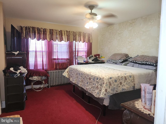 carpeted bedroom with radiator, wallpapered walls, and ceiling fan