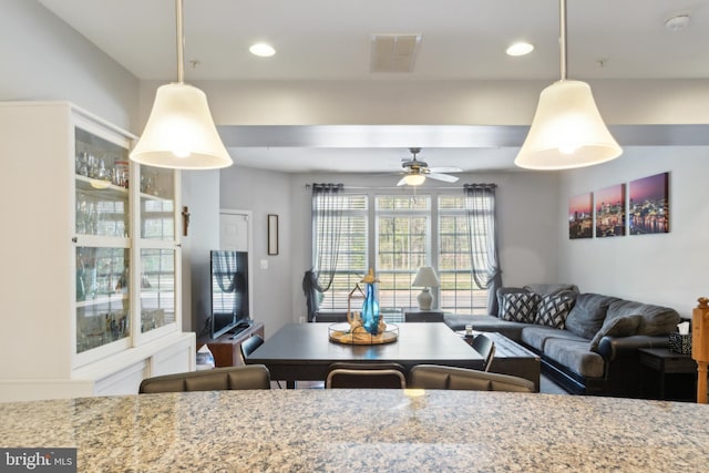 interior space featuring hanging light fixtures, a ceiling fan, recessed lighting, and visible vents