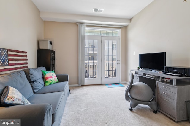 office space featuring carpet floors, baseboards, and visible vents