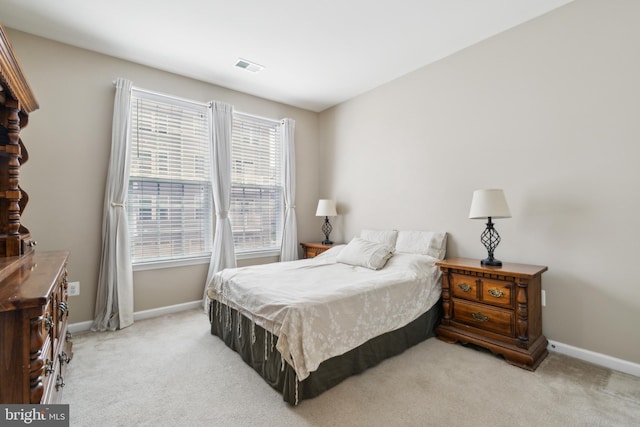 carpeted bedroom with baseboards and visible vents