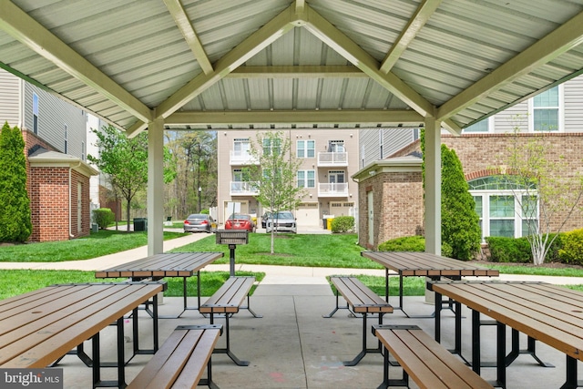 view of home's community featuring a lawn and a patio area