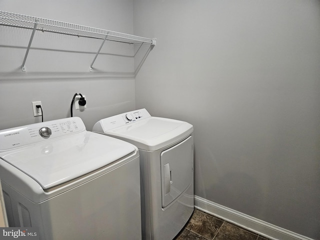 laundry room featuring laundry area, baseboards, and washer and dryer