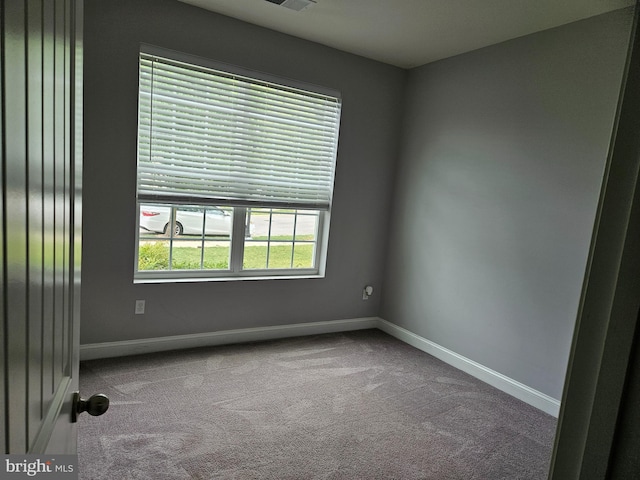 carpeted empty room with baseboards and visible vents