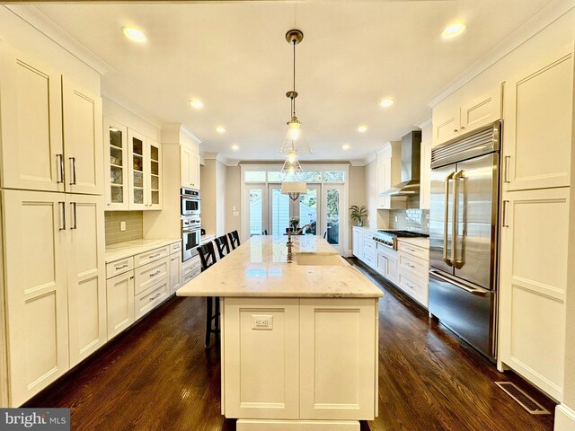 3612 S St NW, Washington, DC 20007 - kitchen with wall chimney range hood, ornamental molding, visible vents, backsplash, and appliances with stainless steel finishes