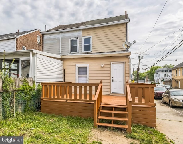 back of house with a deck and fence