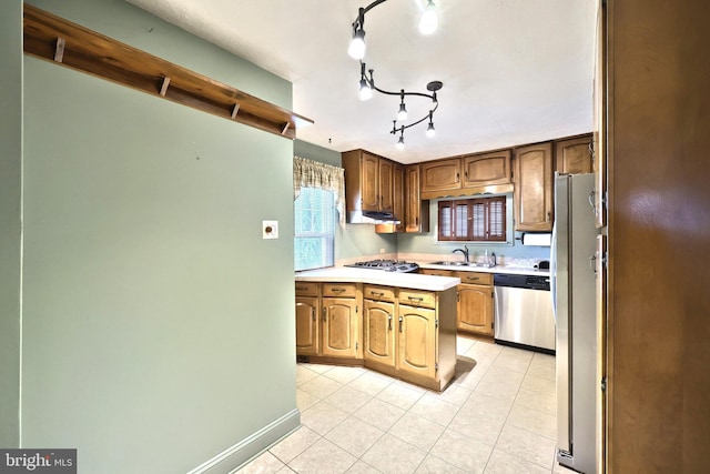 1492 Leonard St, York, PA 17404 - kitchen with appliances with stainless steel finishes, a sink, light countertops, light tile patterned floors, and rail lighting