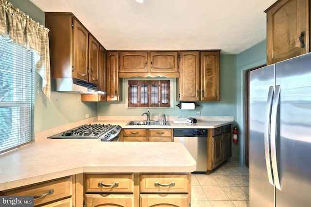 1492 Leonard St, York, PA 17404 - kitchen with appliances with stainless steel finishes, under cabinet range hood, a sink, light countertops, and a peninsula
