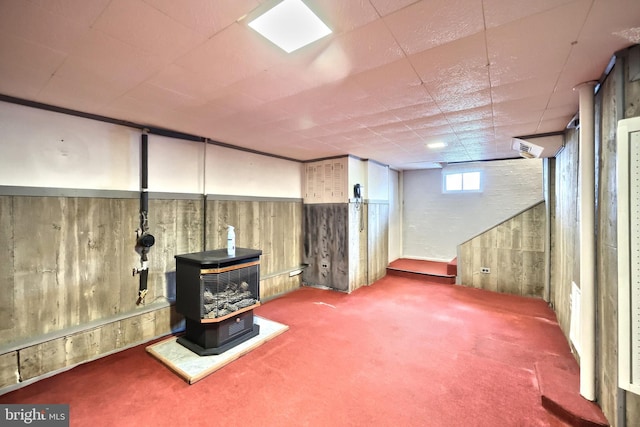 1492 Leonard St, York, PA 17404 - basement featuring carpet floors, a wood stove, and wood walls