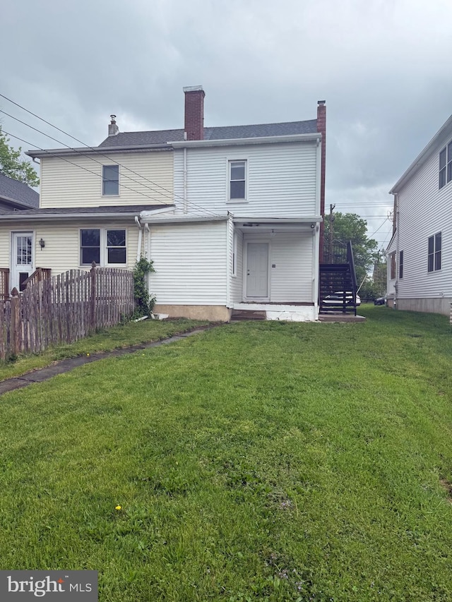 730 Third, Lansdale, PA 19446 - rear view of property featuring a lawn, stairway, fence, and a chimney