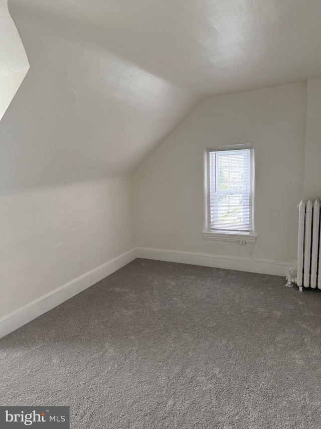 730 Third, Lansdale, PA 19446 - additional living space with dark carpet, radiator, baseboards, and vaulted ceiling