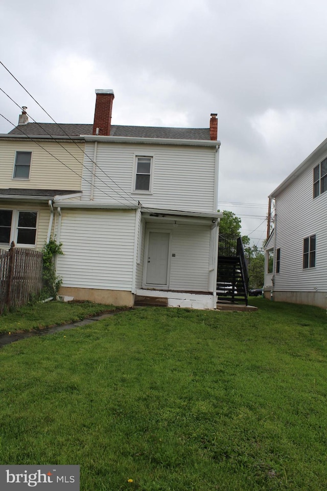 730 Third, Lansdale, PA 19446 - back of house with a lawn, fence, a chimney, and stairs