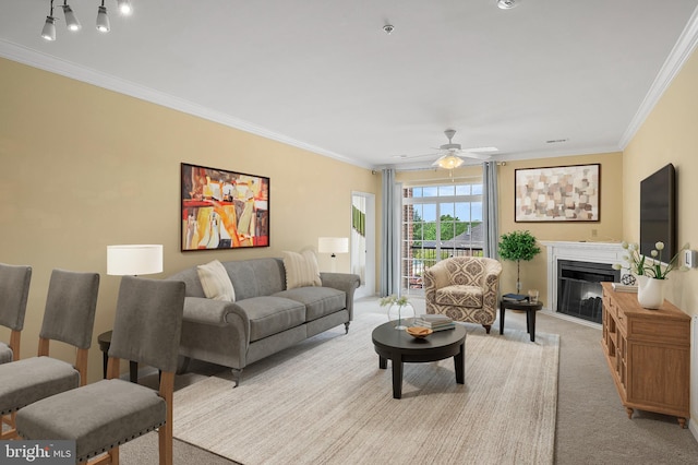 8603 Wintergreen Ct Unit 201, Odenton, MD 21113 - living area featuring crown molding, carpet, a ceiling fan, and a glass covered fireplace