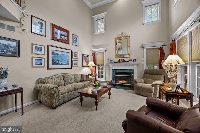 living room featuring crown molding, plenty of natural light, a fireplace, and a towering ceiling