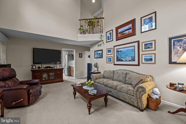 carpeted living room with a towering ceiling, baseboards, and visible vents