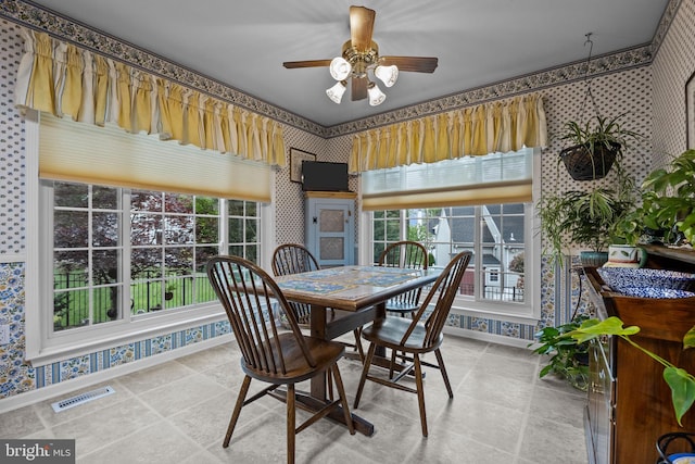dining space with baseboards, visible vents, and wallpapered walls