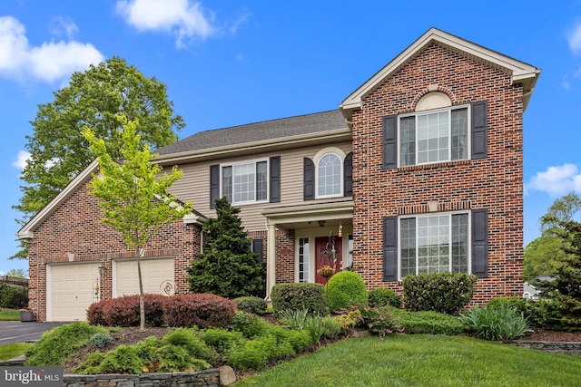traditional-style home with brick siding and aphalt driveway