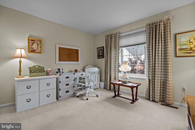 office area featuring light carpet, baseboards, and visible vents