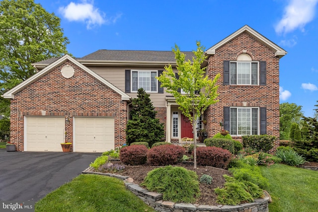 view of front of house featuring a garage, brick siding, and driveway