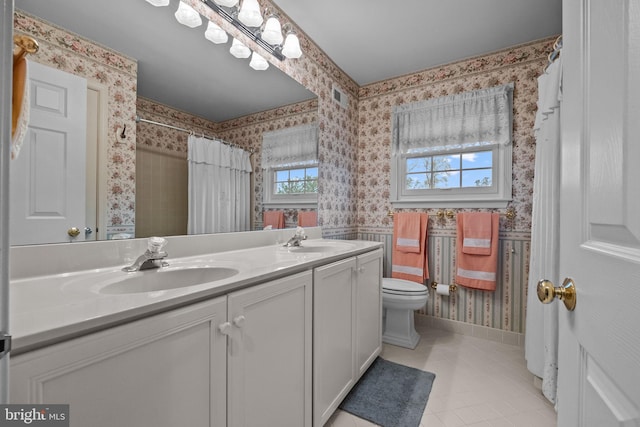 bathroom featuring wallpapered walls, visible vents, tile patterned flooring, and a sink