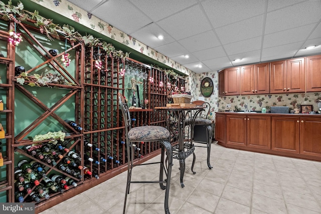 wine room with recessed lighting and a drop ceiling