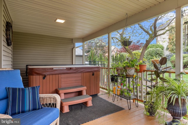 wooden deck with a hot tub